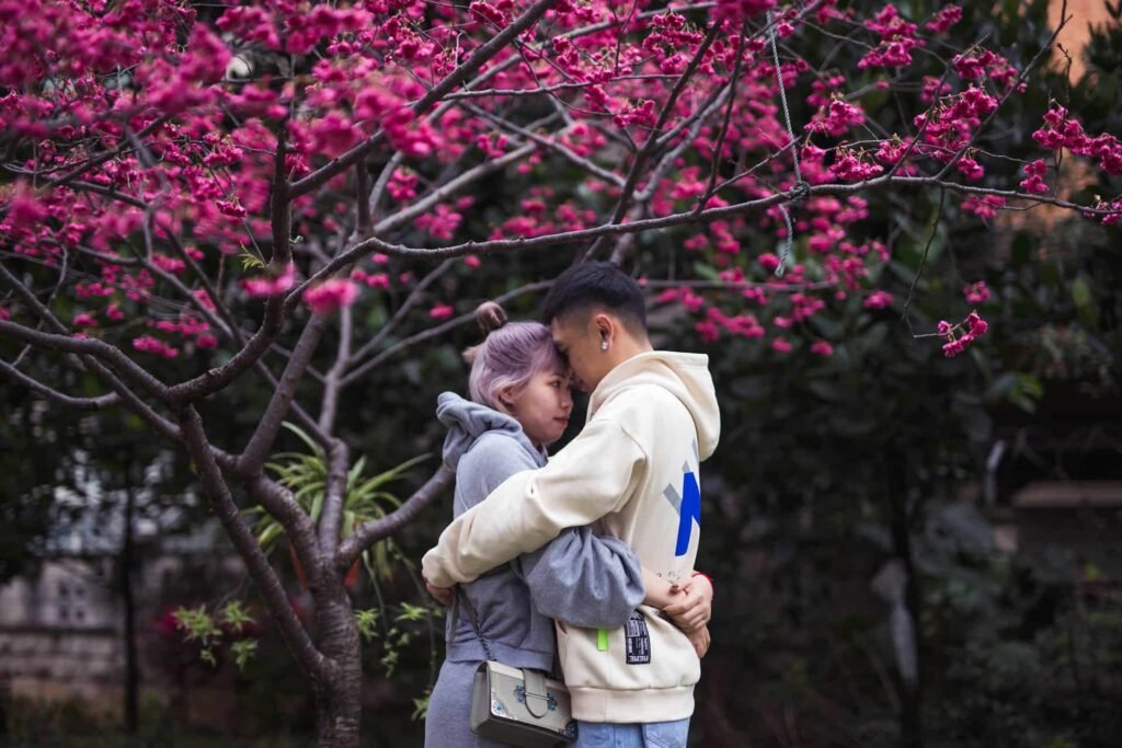 Asian couple embracing on the verge of kissing