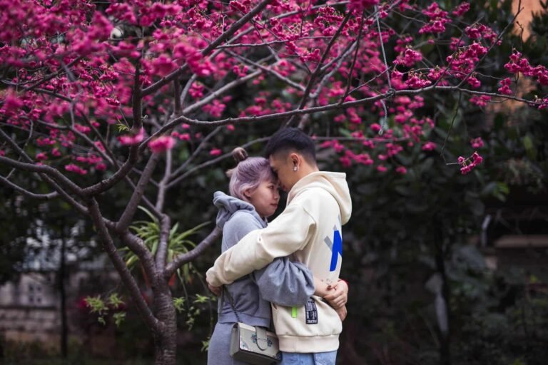 Asian couple embracing on the verge of kissing