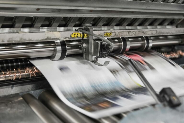 Newspapers coming through the printing press